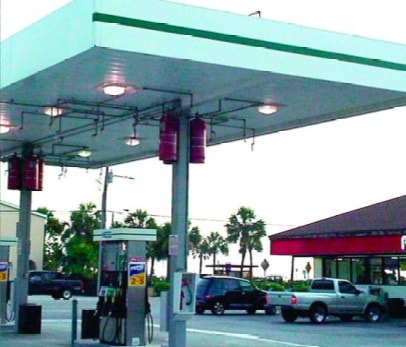 Hanging Cylinders Of A Fire Suppression System Above Gas Pumps